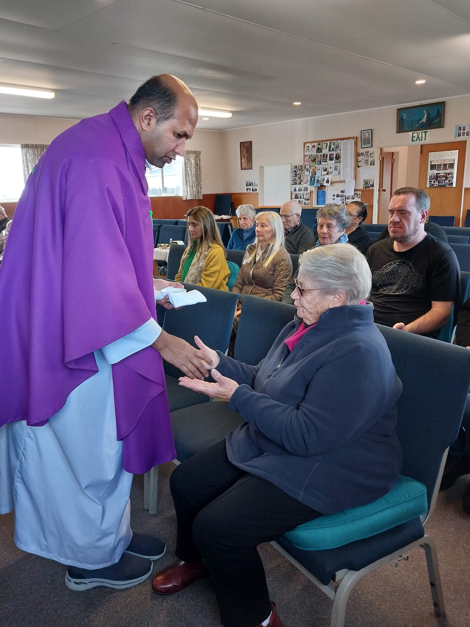 A priest anointing a parishioner